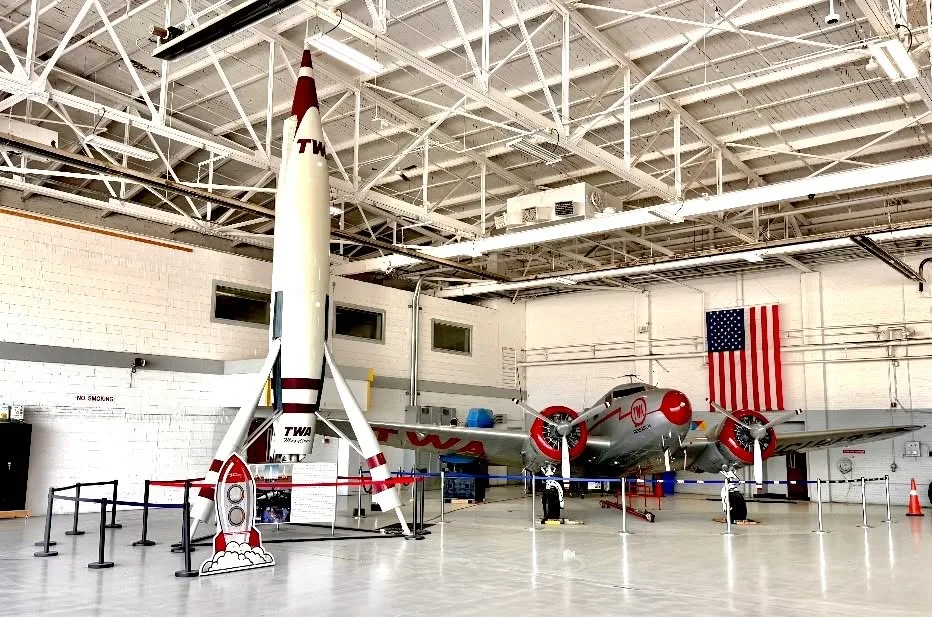 A historical aviation exhibit inside a hangar.