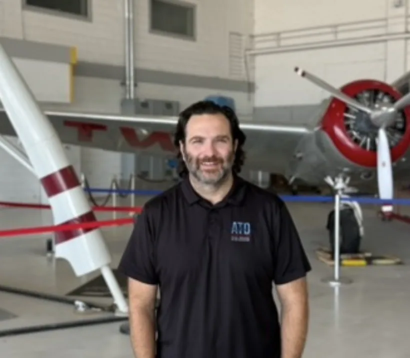 Lute Atieh standing inside an aviation exhibit.